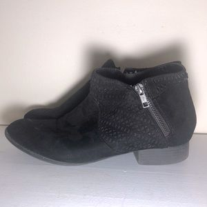 Black booties with cut-out patterns